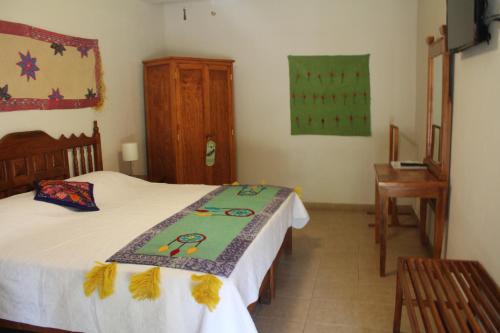 a bedroom with two beds and a desk in it at El Molino Hotel Boutique in Río Verde