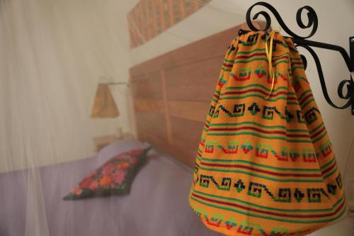 a bag hanging from a wall in a bedroom at El Molino Hotel Boutique in Río Verde