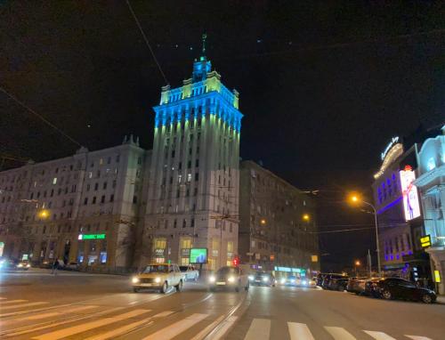 a building with blue lights on top of it at night at Panorama Luxury Apartment in The House with a Spire, a historical building in the city centre in Kharkiv