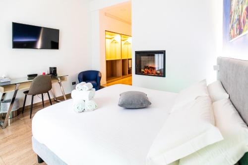 a white bed with two stuffed animals on top of it at Sanfelice 33 Luxury Suites in Naples