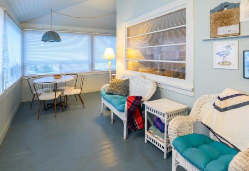 a living room with a table and chairs and a dining room at Karr Beach House on 11th in Seaside