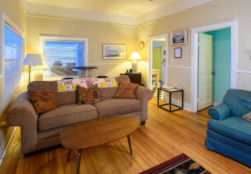 a living room with a couch and a table at Karr Beach House on 11th in Seaside