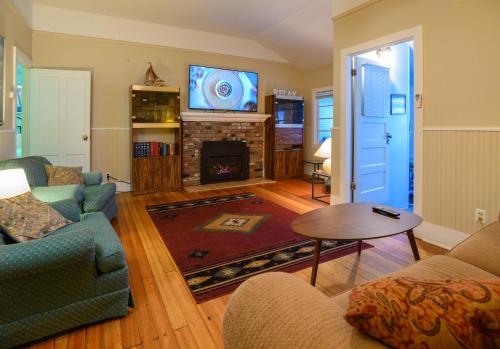 a living room with a fireplace and a tv at Karr Beach House on 11th in Seaside