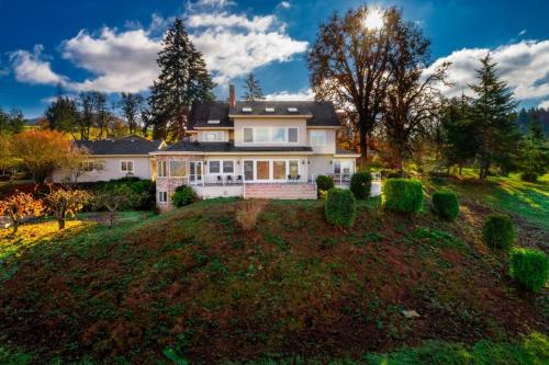 a house on a hill with a yard at Skyview Villa in Newberg