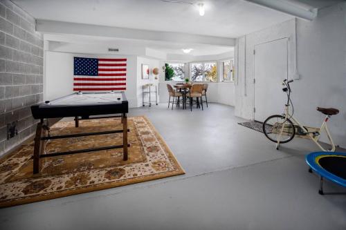 a room with a pool table and an american flag on the wall at Skyview Villa in Newberg