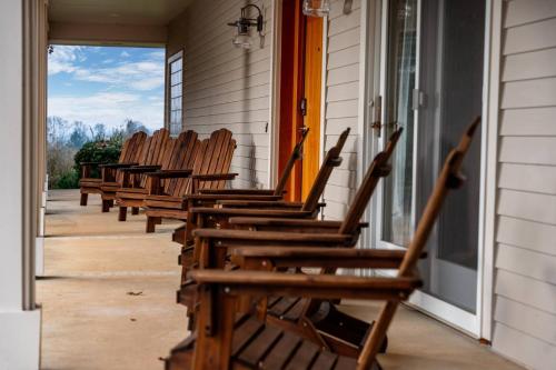 a row of wooden chairs sitting on a porch at Skyview Villa in Newberg