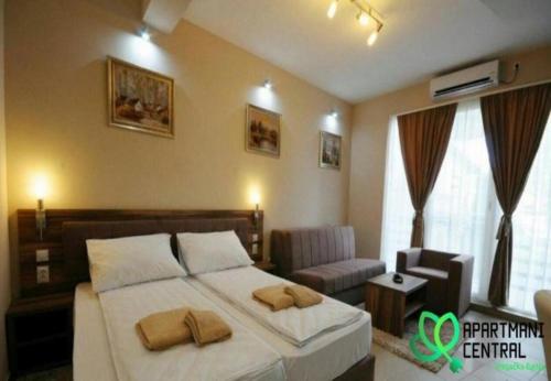 a bedroom with a bed with two pillows on it at Apartmani Central 2.0 & Free parking in Vrnjačka Banja