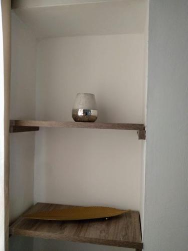a shelf in a room with a clock on it at Monoambiente confortable a pasos de Bv. Oroño in Rosario