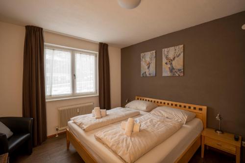 a bedroom with a bed with two pillows on it at Cosy Kaprun Apartment in Kaprun