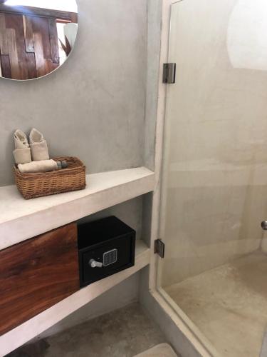 a bathroom with a sink and a mirror at Mamasan Treehouses & Cabins in Tulum
