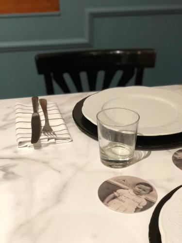 a table with plates and a glass of water on it at Ristorante Locanda Milano in Gambolò