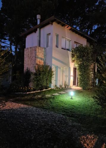 a house with a light in the yard at night at Lucero de las Sierras in Sierra de los Padres
