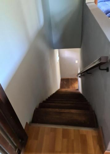 a flight of stairs in a room with wooden floors at Lucero de las Sierras in Sierra de los Padres