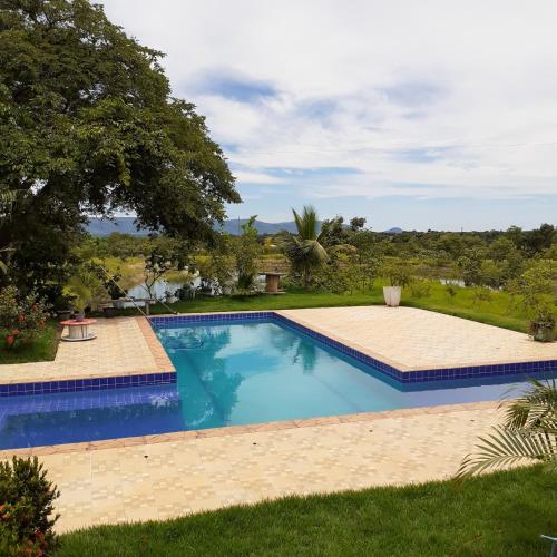 a swimming pool in the yard of a house at Pousada Terra de Minas in Aristeu