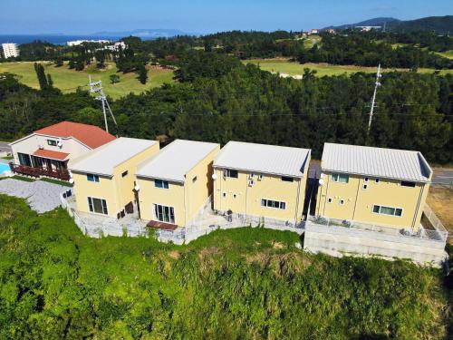 an aerial view of a house on a hill at Irie House Fuchaku in Onna