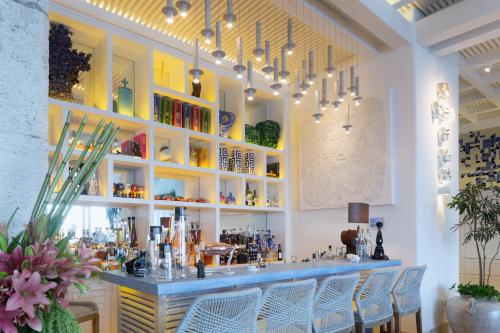 a restaurant with a bar with chairs in a room at Villa Sha - Cancun Luxury Beachfront in Cancún
