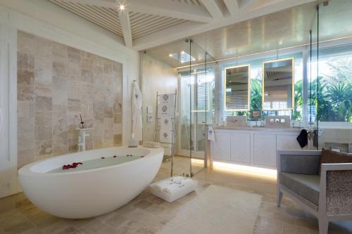 a large bathroom with a large tub and a shower at Villa Sha - Cancun Luxury Beachfront in Cancún