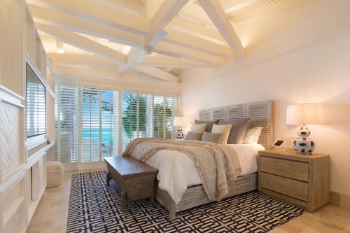 a bedroom with a large bed with a coffered ceiling at Villa Sha - Cancun Luxury Beachfront in Cancún