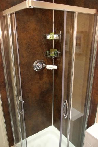 a shower with a glass door in a bathroom at Avondale Guest House in Keswick