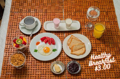 a breakfast table with breakfast foods and drinks on it at Colonial House Inn in Quito