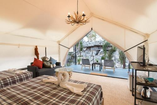 a bedroom with two beds and a living room at Mont Blanc Base Camp Khaoyai in Pak Chong