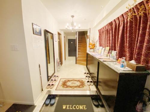 a hallway with a room with a rug on the floor at GuestHouse017徳島個室 飲食街中心 阿波踊り会館7分 文理&徳島大学 アスティとくしま車8分 in Tokushima