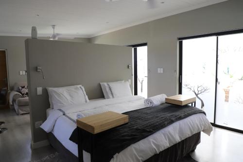 a bedroom with a large bed with a large window at Memories Made Cottage in Kampersrus AH