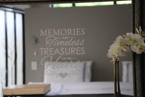 a mirror with a reflection of a bed in a room at Memories Made Cottage in Kampersrus AH