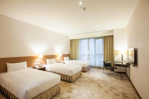 Postel nebo postele na pokoji v ubytování Taisugar Hotel Taipei