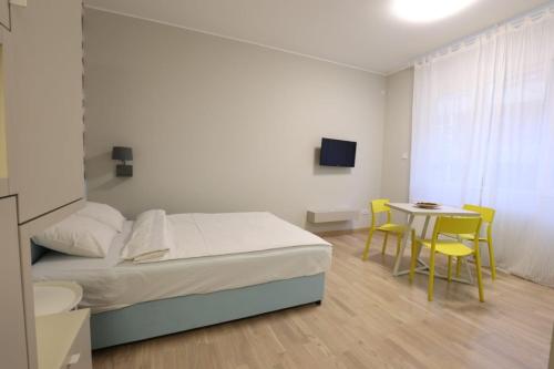 a bedroom with a bed and a table and chairs at Belgrade Center Apartment VI in Belgrade