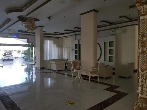a living room with a couch and a table at Address hotel Apartments العنوان للشقق الفندقية in Aş Şa‘arah