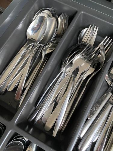a tray of silver utensils in a drawer at Vakantiehuis Veluwe Wageningen in Wageningen