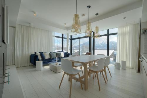 a kitchen and dining room with a table and chairs at Loft Niseko in Kutchan