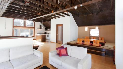 a living room with a white couch and a table at Ginsetsu in Kutchan