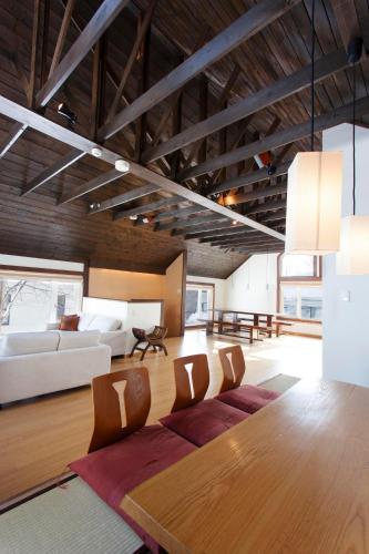 a living room with a table and a couch at Ginsetsu in Kutchan