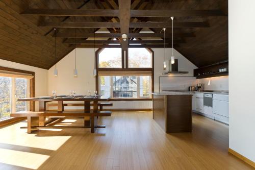 a large kitchen with a wooden table in a room at Ginsetsu in Kutchan