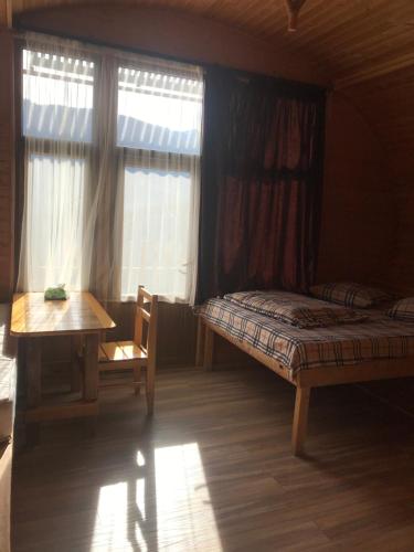 a bedroom with a bed and a table and window at Harsnadzor Eco Resort in Halidzor