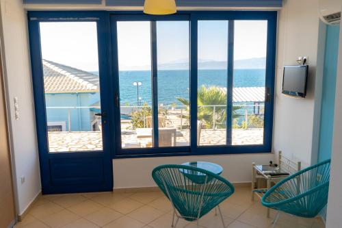 a room with a door with a view of the ocean at Iris Villas in Spárton
