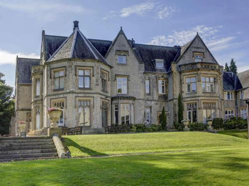 a large house with a large lawn in front of it at Mercure Sheffield Kenwood Hall & Spa in Sheffield