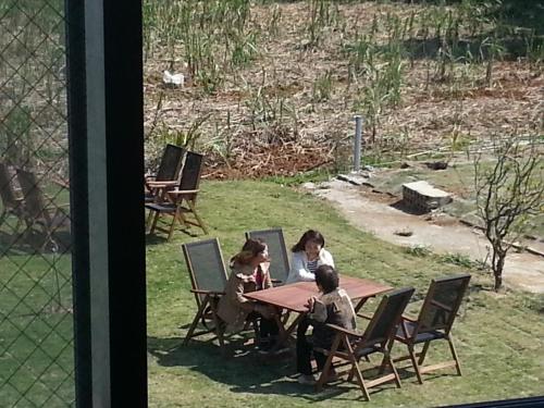 two children sitting at a table with a laptop at Minshuku Myojoso in Yoron