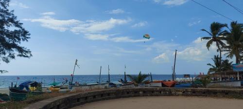a kite flying in the sky over the beach at 'Golden Sunset' 3bhk beach villa in Benaulim