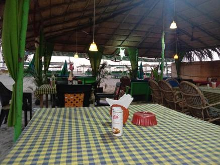 a table with a blue and yellow checkered table cloth at Lamarine Morjim Beach cottages in Old Goa