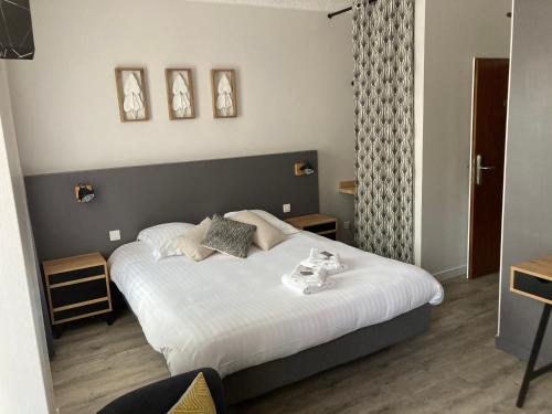 a bedroom with a large bed with white sheets at Dolce Vita in Mondorf-les-Bains