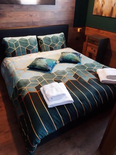 a bed with towels and pillows on top of it at Suite il sogno di Grebek in Passo del Tonale