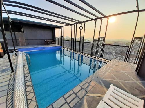 a swimming pool on the top of a building at Suvin Residency with Rooftop Swimming Pool in Udaipur