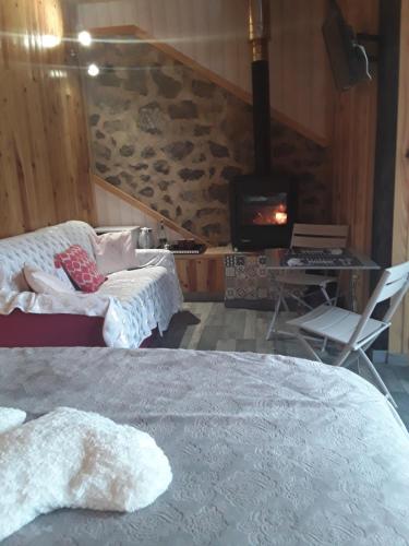 a bedroom with a bed and a fireplace and a tv at A La Belle Epoque in Valdeblore