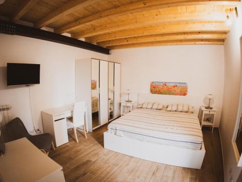 a bedroom with a bed and a desk and a tv at FLATS 15 - New Opening in Rome
