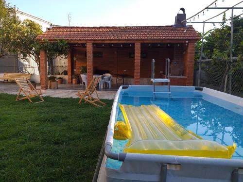 a pool with a slide in a backyard at Sweet Home Near Black Sea in K'obulet'i