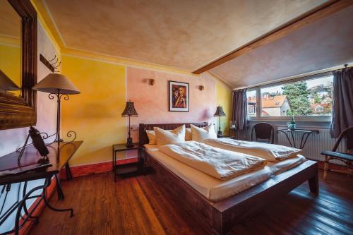 a bedroom with a bed and a large window at Ristorante e Pensione La Campagnola in Dresden