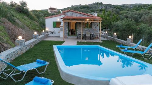 a villa with a swimming pool and a house at Villa Elia in Lambiní